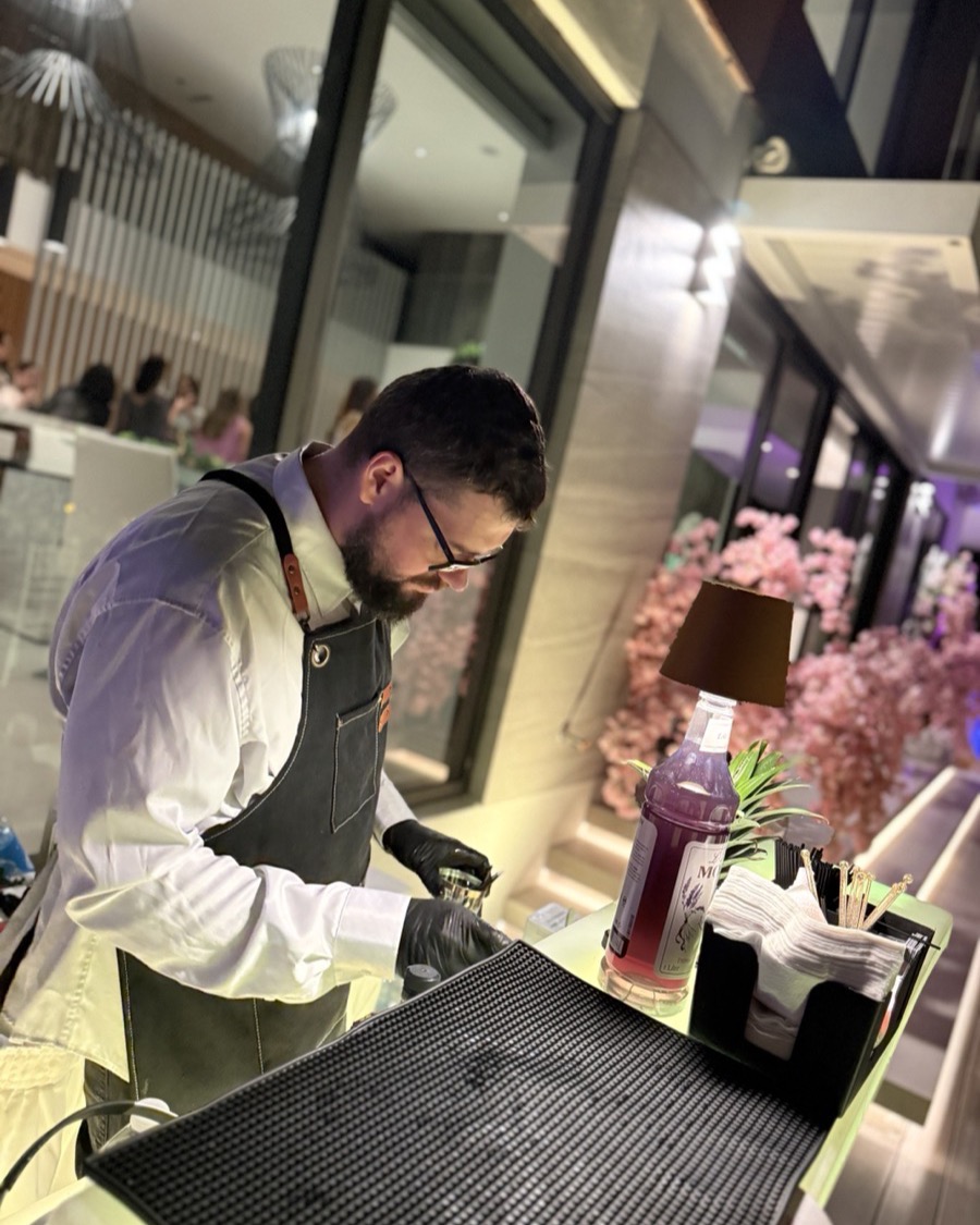 Bartender preparing colorful mocktail drinks pink flowers Miami