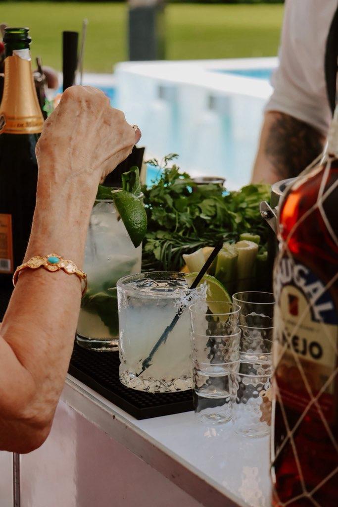Guest reaching for a margarita at a poolside bar in Miami