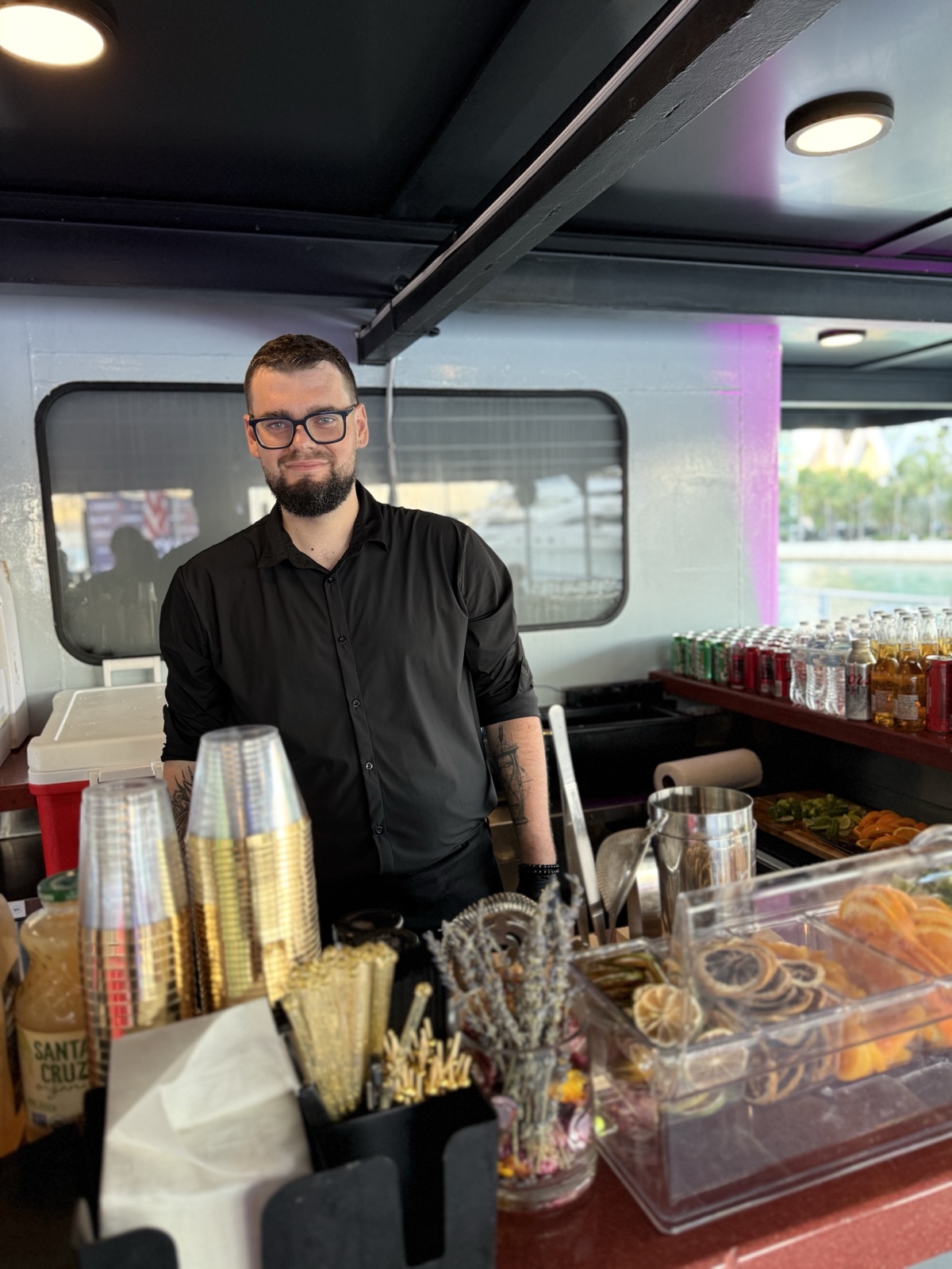 Bartender pouring drinks on a yacht off Biscayne Bay